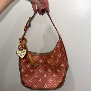 Pink Dooney and Burke shoulder bag with brand print and original hardware